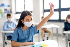 Girl with face mask back at school - local school & students